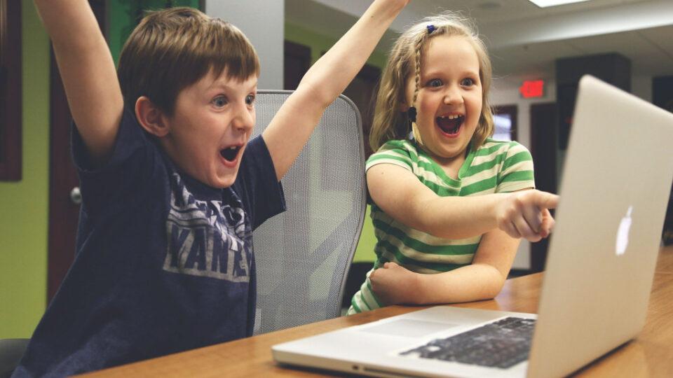 Happy children in front of a laptop